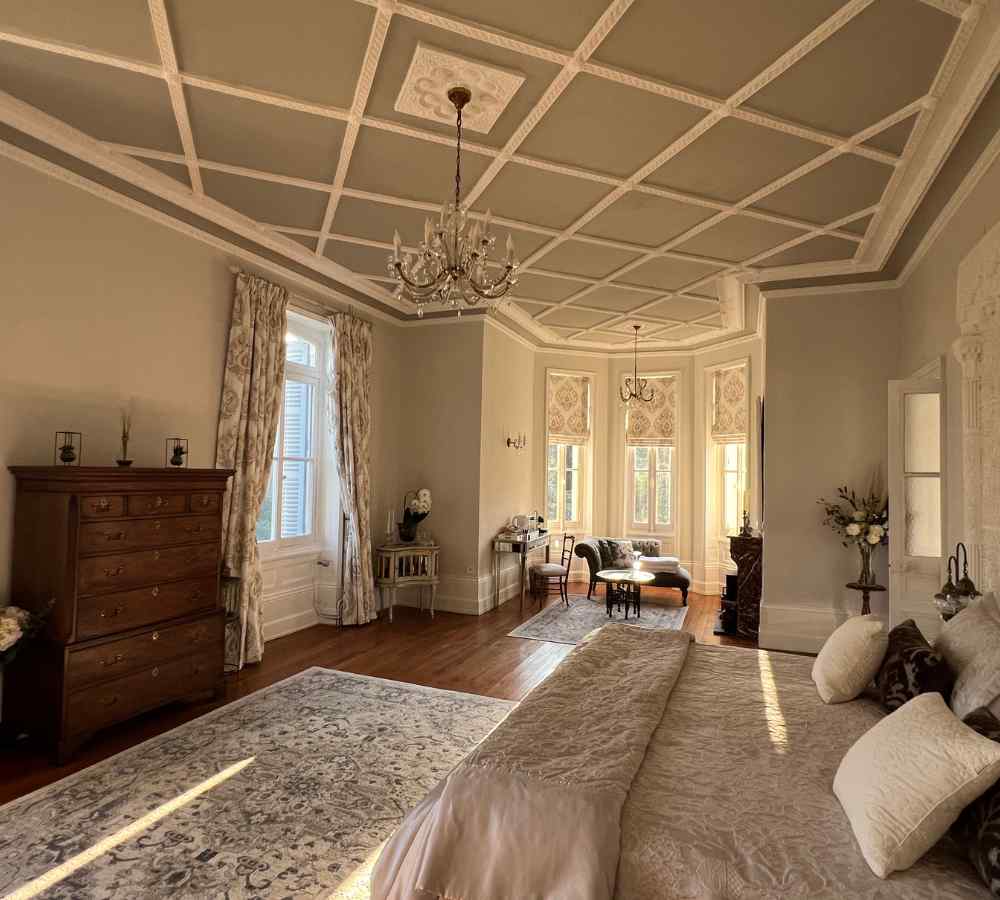 Elegant bridal suite inside Château de la Boutinière, featuring high ceilings, chandeliers, and soft natural light, ideal for preparations at a micro wedding venue in France.