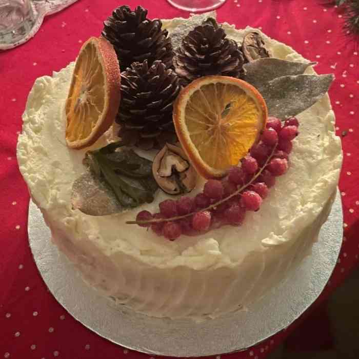 Seasonal cake topped with dried orange slices, berries and pine cones at Château de la Boutinière.
