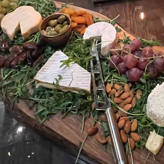 Cheeseboard with French cheeses, fruit, nuts and olives prepared at Château de la Boutinière.