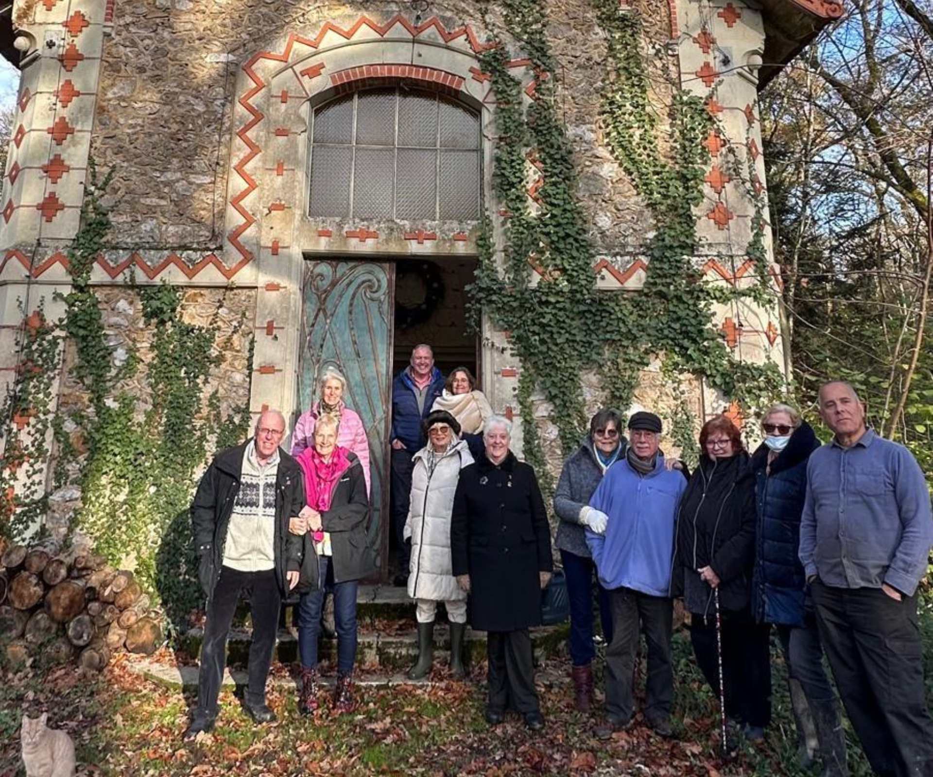 Group of guests gathered outside the ivy-covered entrance of Château de la Boutinière during one of our Chateau Events in the French countryside.