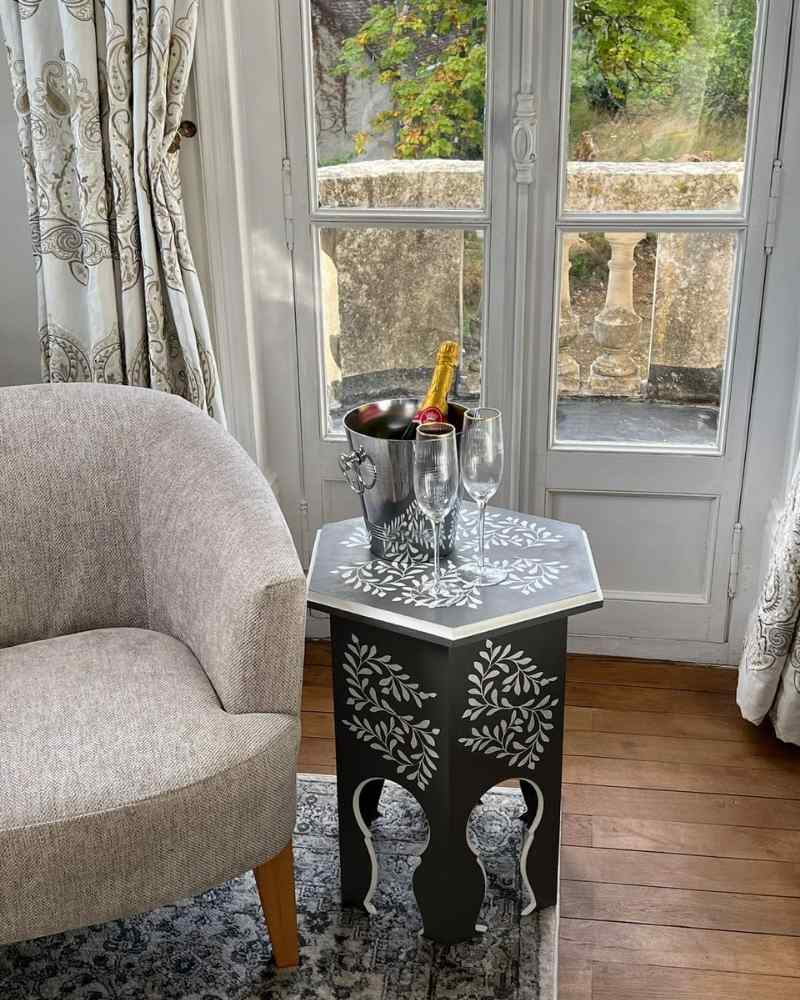 Detail of patterned curtains and side table in the bridal suite at Château de la Boutinière, created in collaboration with our specialist partners.