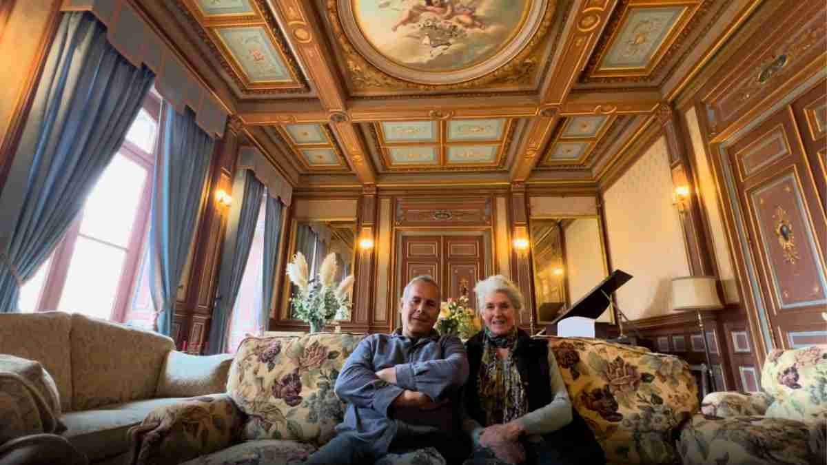 Alison and Zion seated inside Château de la Boutinière, where they are now sharing more of the château’s rooms, stories and renovation journey on Patreon.
