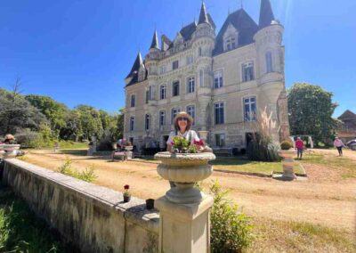 Chateau events gardening day showing a wide front view of Château de la Boutinière with guests working in the grounds.