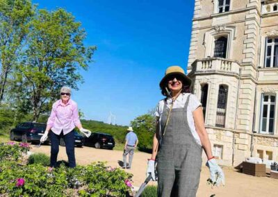 Chateau events gardening day with two women working in the flower beds and grounds at the front of the château.