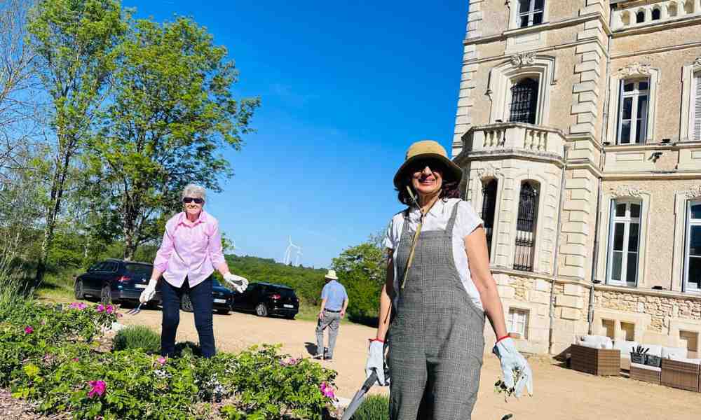 Chateau events gardening day with two women working in the flower beds and grounds at the front of the château.