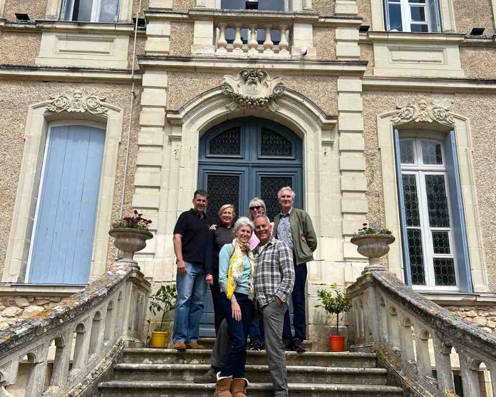 Guests standing at the entrance of Château de la Boutinière during a Behind the Scenes Château Stay.