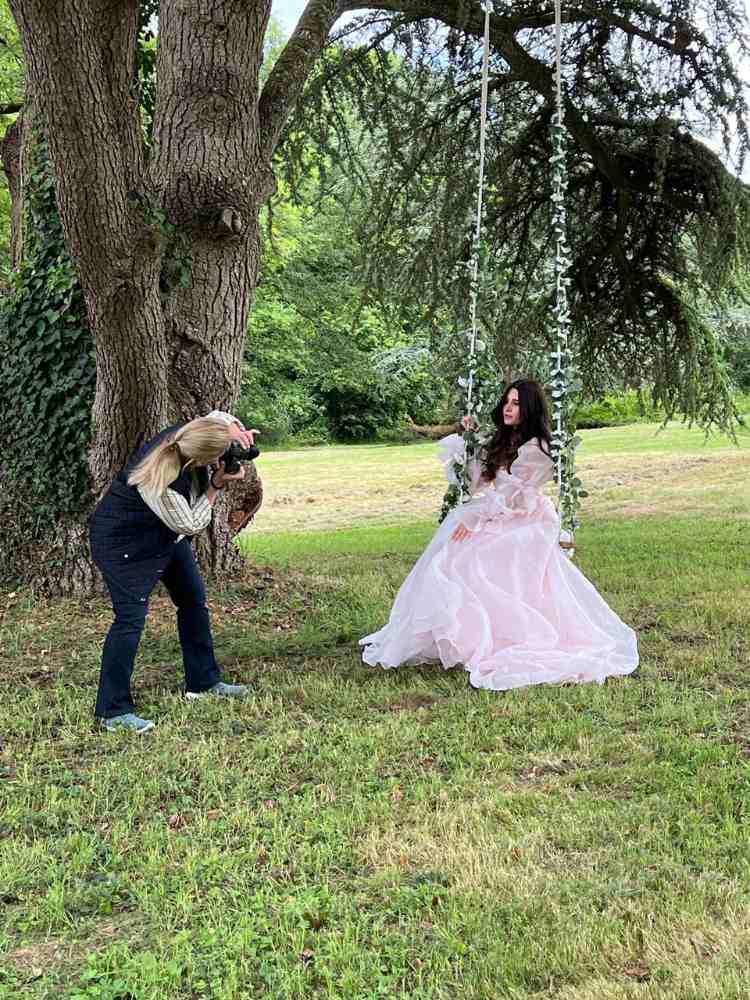 Louren photographing Doreen on a floral swing in the grounds of Château de la Boutinière.