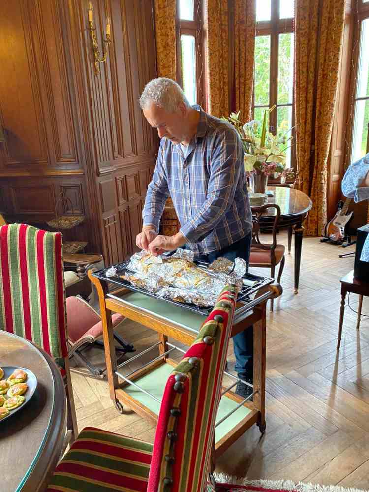 Salted salmon being prepared for guests during a Château Stay at Château de la Boutinière.